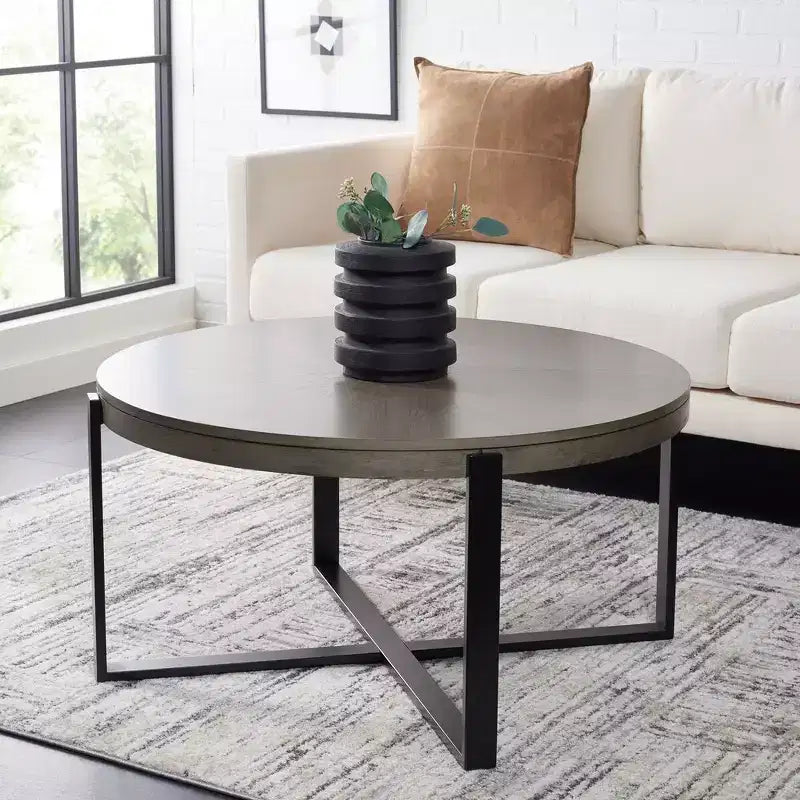 Table basse ronde avec piétement métallique entrecroisé